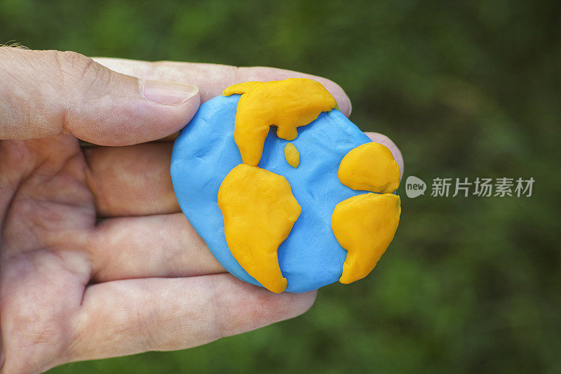 Man holding planet Earth in his hand